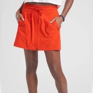 Athleta front zipper, pull on, stretch, drawstring orange skort size 4